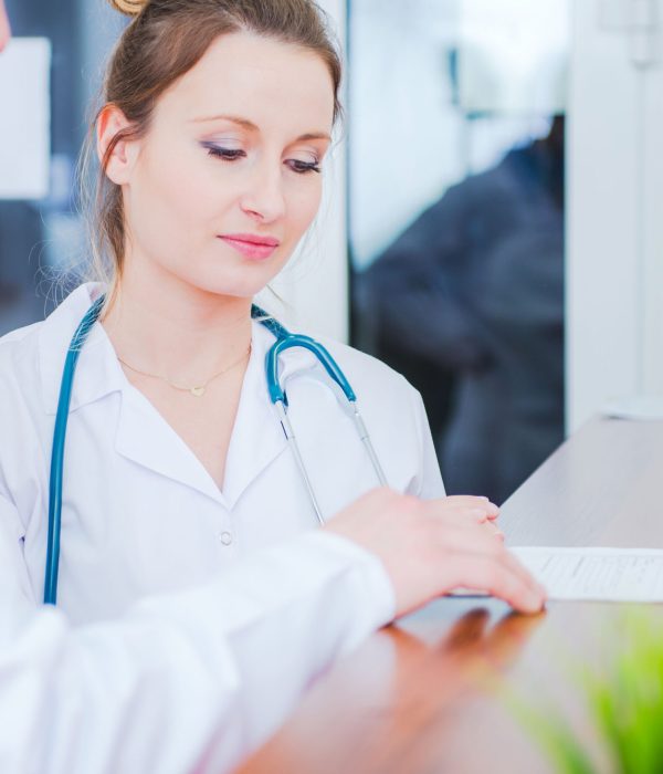 Caucasian Female Medical Worker in White Lab Coat Making Conversation with Doctor. Healthcare Industry.