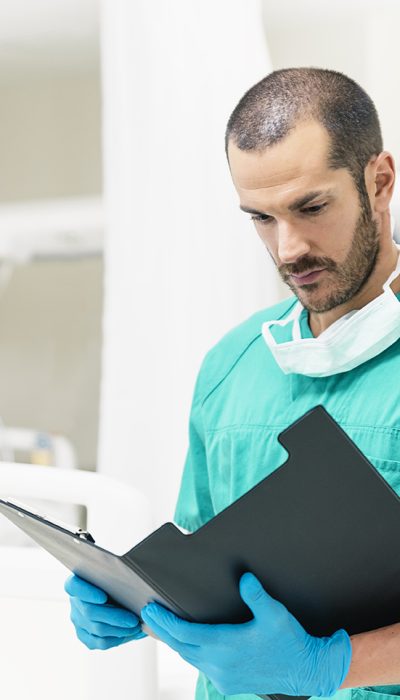 Medical nurse worker examining a medical report in hospital room