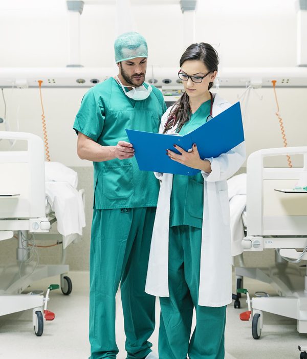 Medical team workers  examining a medical report in hospital room